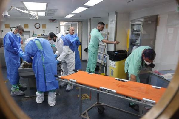 Forensic scientists at Israel's Natio<em></em>nal Center for Forensic Medicine in Tel Aviv work to identify bodies of those killed in attacks by Hamas.