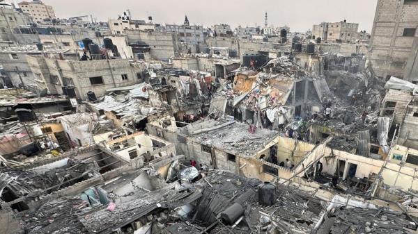 People search through the rubble of damaged buildings following an Israeli air strike on Palestinian houses in Rafah, in the southern Gaza Strip