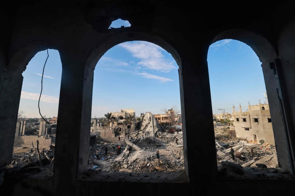 Palestinians stand amidst the rubble of buildings destroyed in Israeli bombardment in Rafah, southern Gaza Strip, Palestine, Jan. 25, 2024. (AFP Photo)