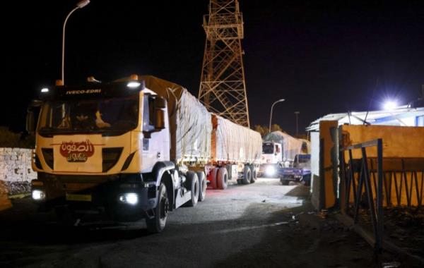 Libyan trucks carrying various food products pass the Ras Jedir border post with Tunisia