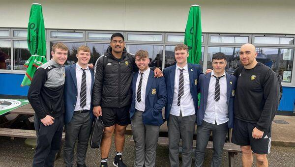 La Rochelle players Will Skelton and Ultan Dillane pose for pictures with members of the PBC Munster Schools Cup-winning team at Cork Constitution's Temple Hill grounds on Thursday. 