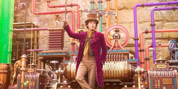 Timothee Chalamet as Wo<em></em>nka Standing in front of a Colorful Machine in Wonka