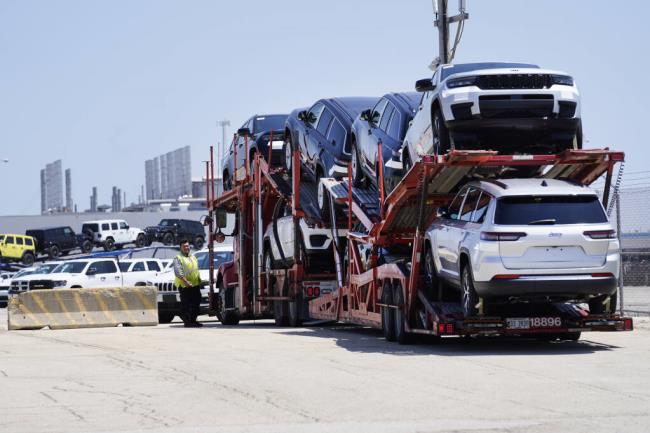 A transport carrying new cars arrives at a Stellantis facility on Monday, July 10, 2023, in Belvidere. Ill. On Thursday, the Commerce Department issues its first of three estimates of how the U.S. eco<em></em>nomy performed in the second quarter of 2023. (AP Photo/Charles Rex Arbogast)