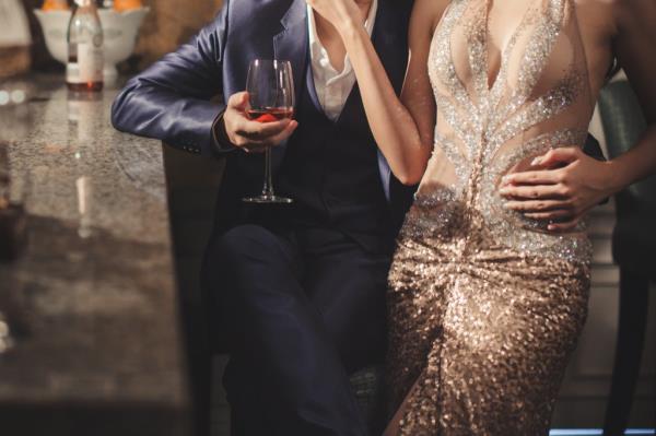 man wearing a suit at a bar