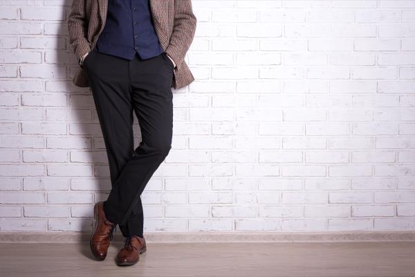 man wearing plaid blazer black pants and brown shoes