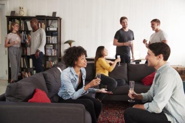 A group of friends at a party in a New York loft apartment