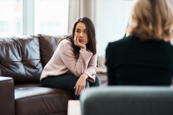 shot of a young woman havin<em></em>g a therapeutic session with a psychologist